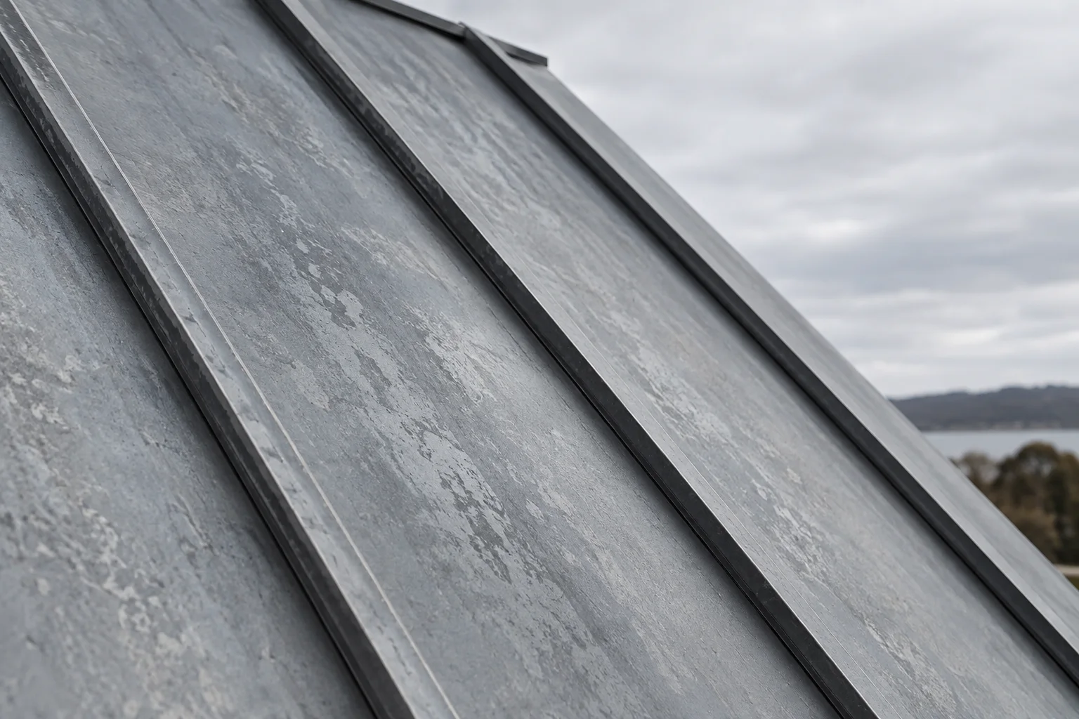 A close-scale study of the Zinc Addition’s standing seams and folded roof plane.
